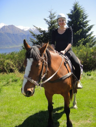 horse and rider with mountains in background