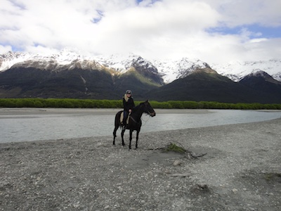 horse and rider in front of mountains
